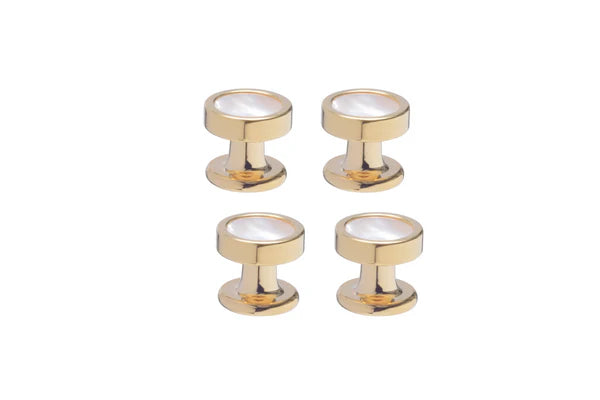 Four gold button studs with mother of pearl centers on a white background