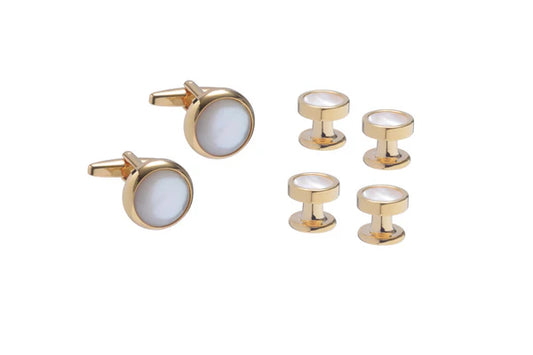 Gold cufflinks and matching shirt studs on a white background