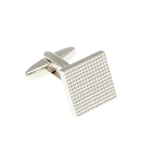 Silver cufflink with textured design on a white background