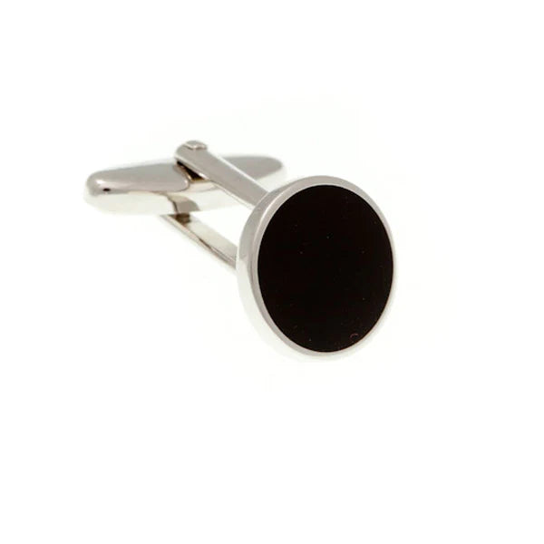 Silver cufflink with a black stone on a white background