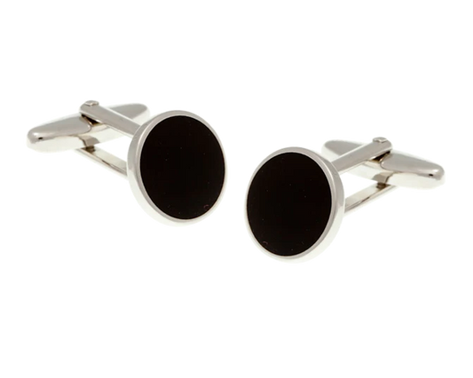 Round cufflinks with black centers and silver borders on a white background