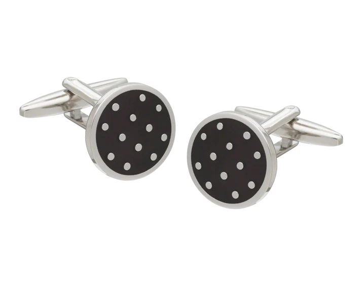 Round cufflinks with black background and white dots on a white background