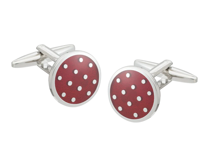 Cufflinks with red circular design and white polka dots on a white background