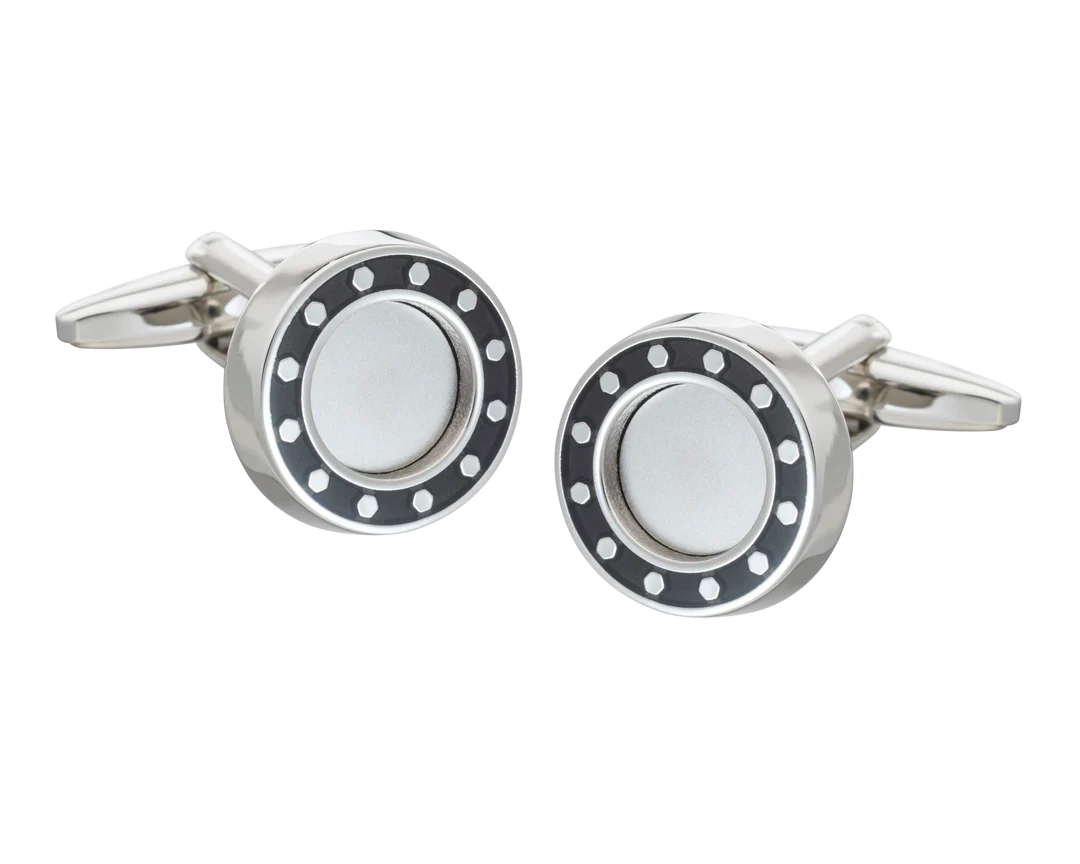 Silver cufflink with black and white design on a white background