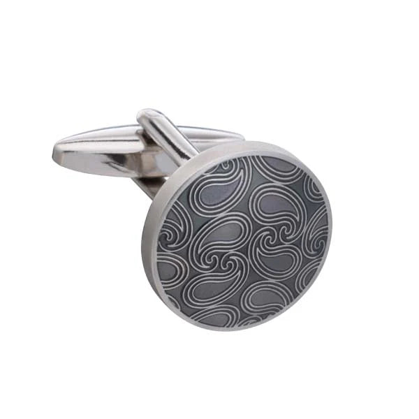 Cufflink with a silver and black pattern on a white background