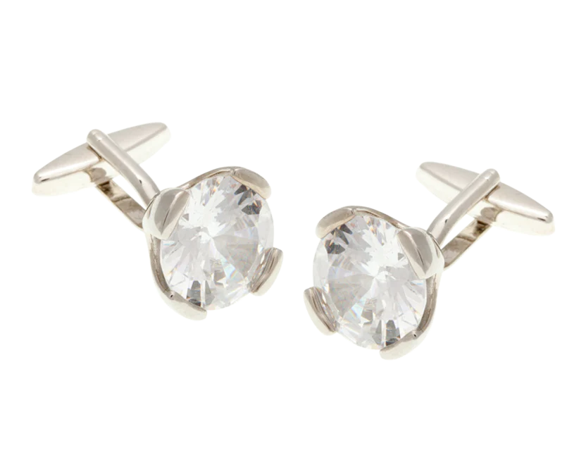 Silver cufflinks with clear gemstones on a white background