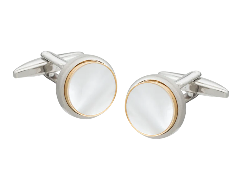 Silver and gold cufflink on a white background