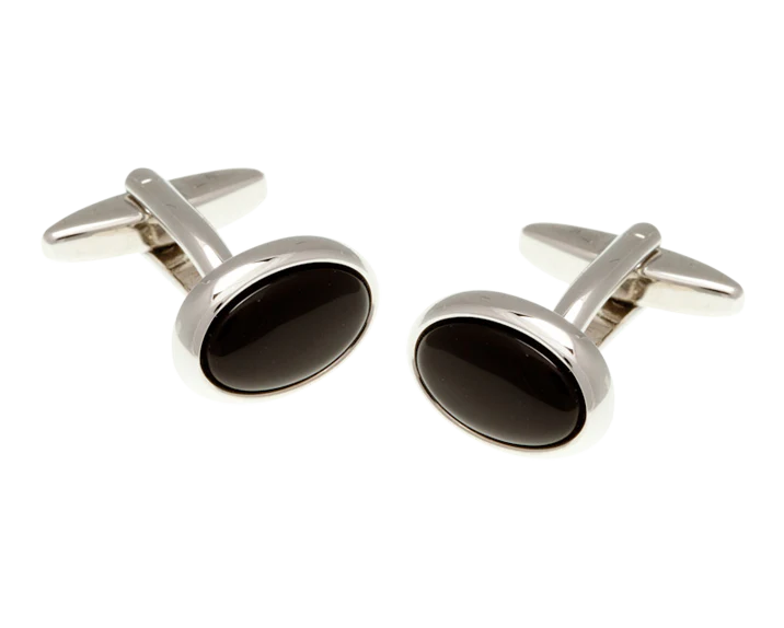 Pair of silver cufflinks with black stones on a white background
