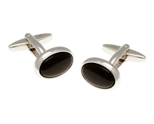 Pair of silver cufflinks with black stones on a white background