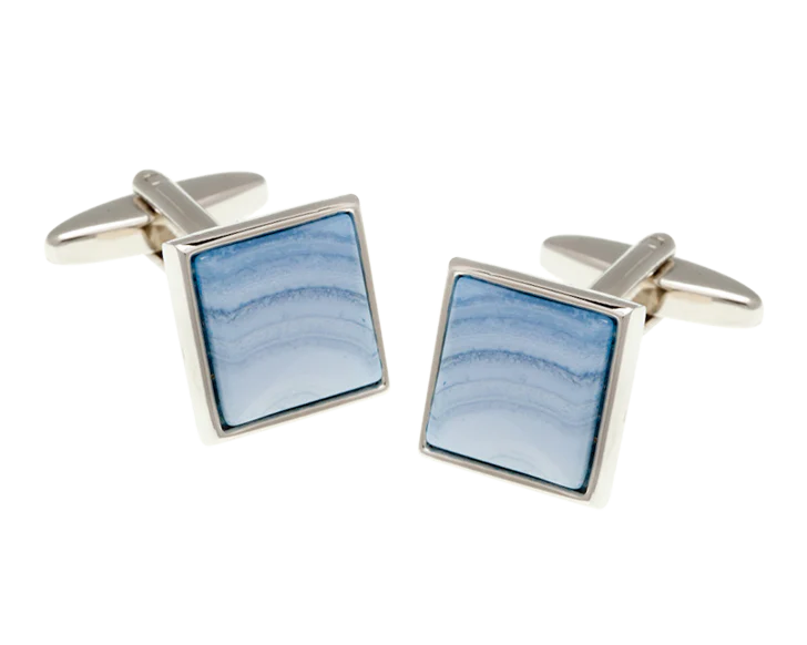 Square cufflinks with blue stone inlay on a white background
