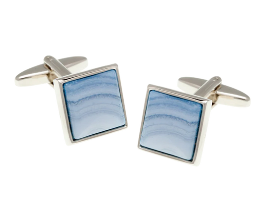 Square cufflinks with blue stone inlay on a white background