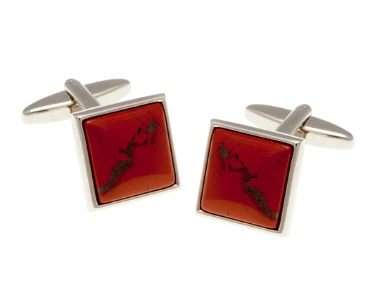 Square cufflinks with red stone and silver frame on a white background