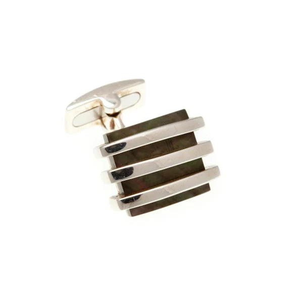 Cufflink with striped design on a white background