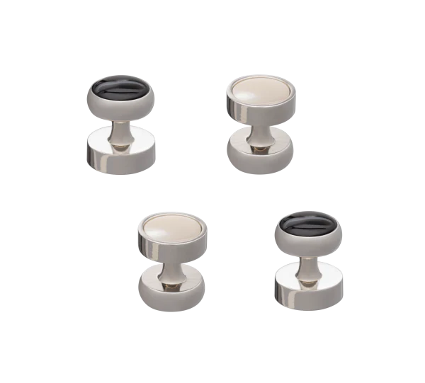 Set of four metallic button studs on a white background