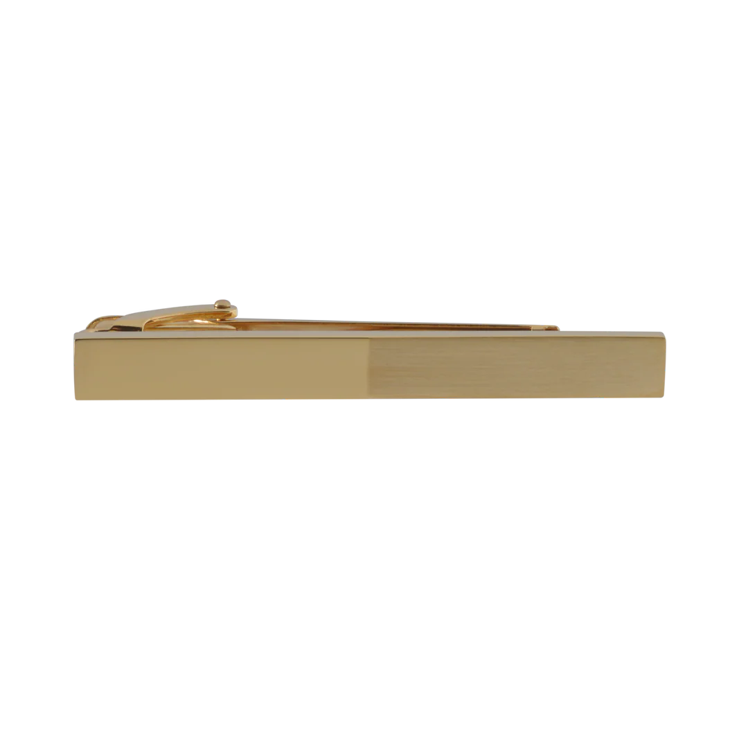 Gold tie clip on a white background