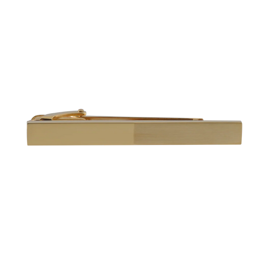 Gold tie clip on a white background
