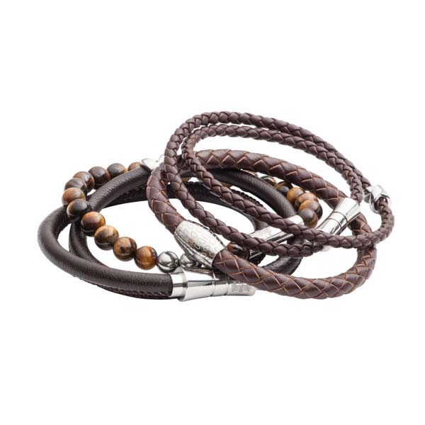 Set of braided leather bracelets with metal accents on a white background