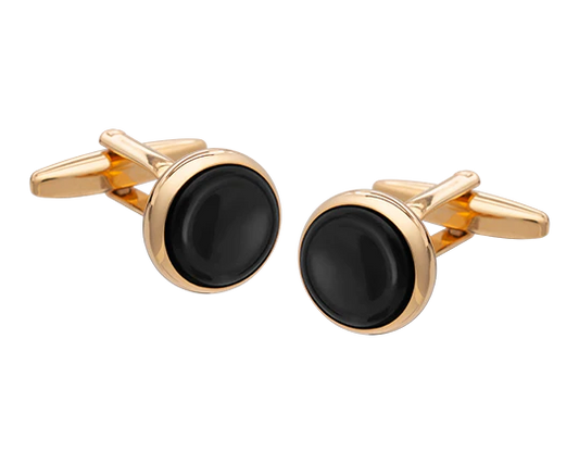 Gold cufflinks with black stones on a white background