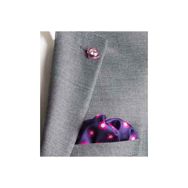 Gray blazer with a purple polka dot pocket square on a white background