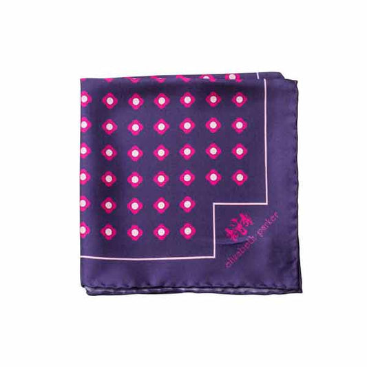 Navy pocket square with pink polka dots and brand logo on a white background