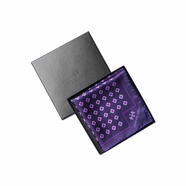 Purple patterned pocket square in a black box on a white background