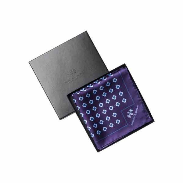 Purple pocket square with blue geometric pattern in a black box on a white background