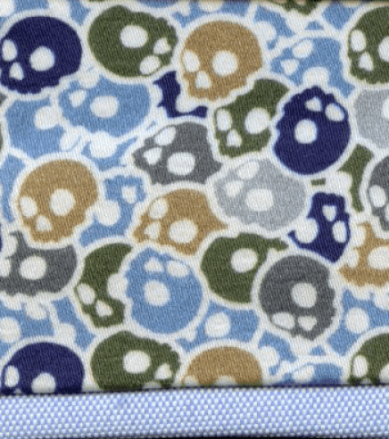 Patterned fabric with colorful skulls on a blue background