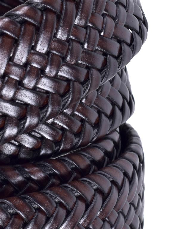 Close-up of braided brown leather cord on a white background