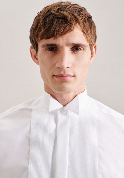Man wearing a white dress shirt against a plain background