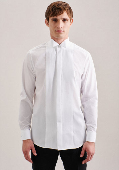 Man wearing a white dress shirt against a plain background