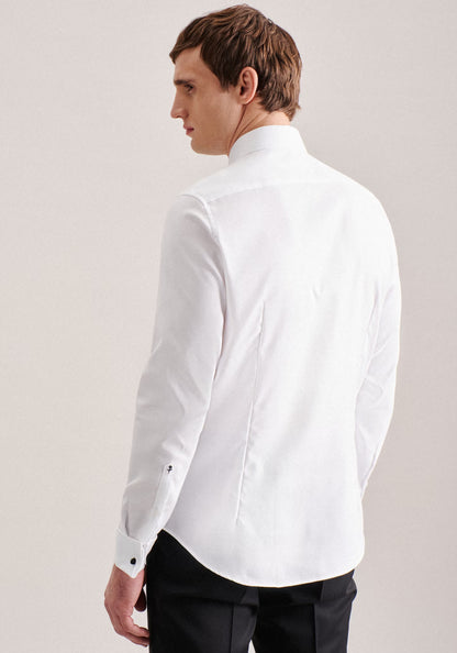 Man wearing a white dress shirt and black pants on a plain background
