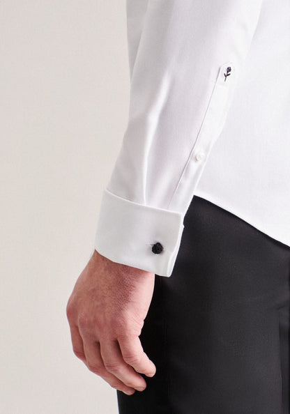 White dress shirt with black cufflinks and cuff details, worn with black pants on a light background