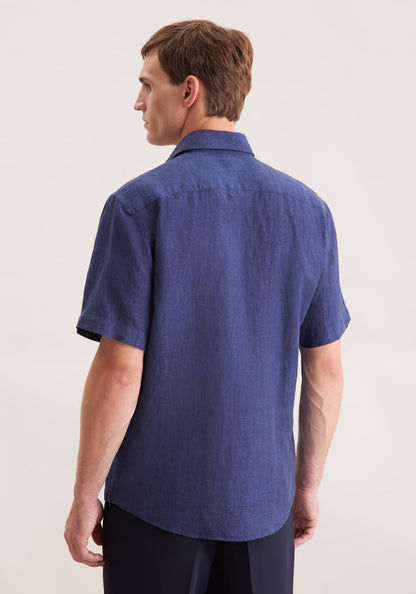 Man wearing a blue short-sleeve shirt on a plain background