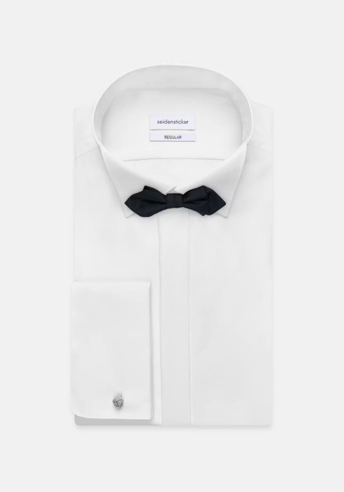 White dress shirt with a black bow tie and cufflink on a white background