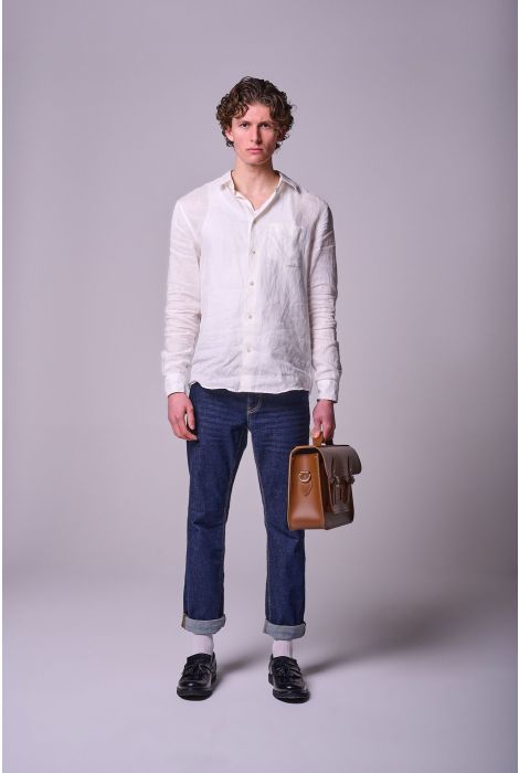 Man wearing a white shirt and blue jeans holding a brown leather briefcase against a plain background