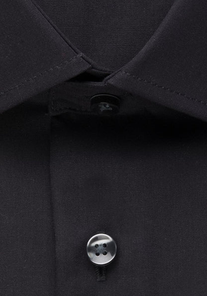 Close-up of a black shirt with a button on a dark background
