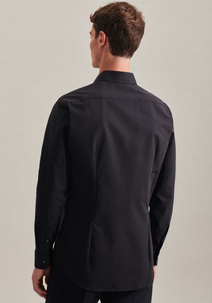 Man wearing a black dress shirt against a plain background