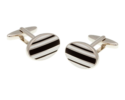 Silver cufflinks with black stripes on a white background