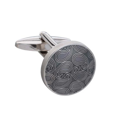 Cufflink with a silver and black pattern on a white background