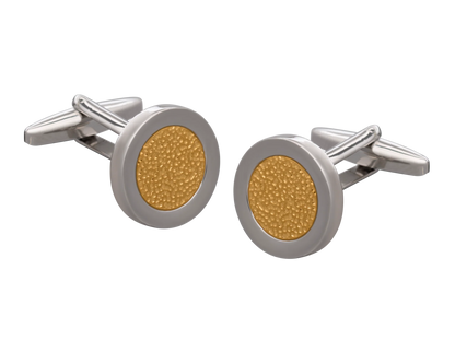 Gold and silver cufflinks on a white background