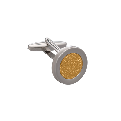 Cufflink with gold center and silver frame on a white background