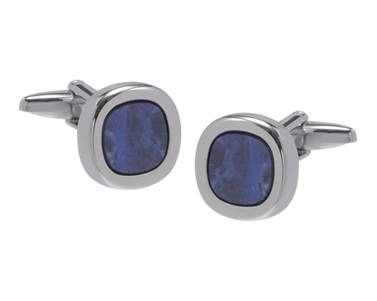 Cufflinks with blue circular stones on a white background
