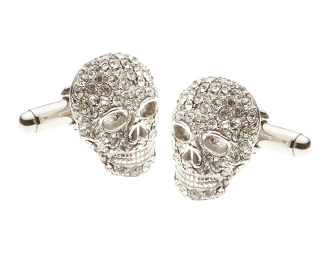 Skull-shaped cufflinks with gemstones on a white background
