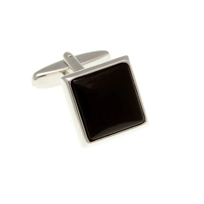 Pair of square black cufflinks with silver borders on a white background