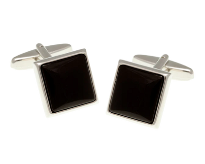 Pair of square black cufflinks with silver borders on a white background