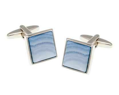 Square cufflinks with blue stone inlay on a white background