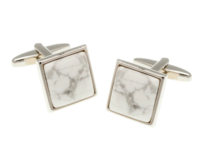 Square marble-patterned cufflinks with gold edges on a white background
