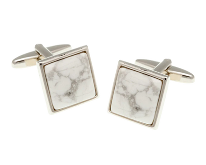 Square marble-patterned cufflinks with gold edges on a white background