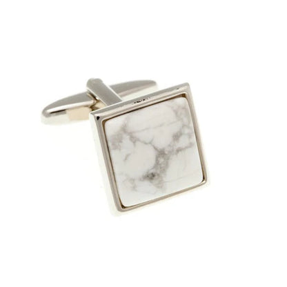 Square cufflinks with marble pattern on a white background