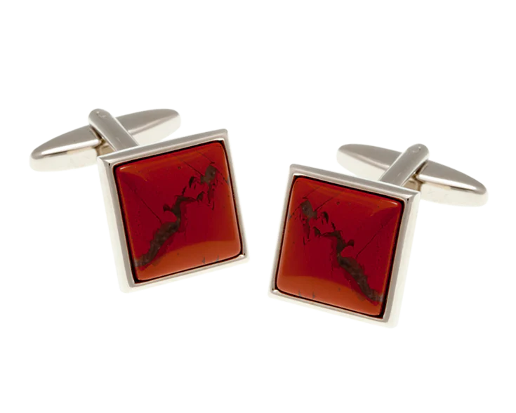 Square cufflinks with red stone and silver frame on a white background
